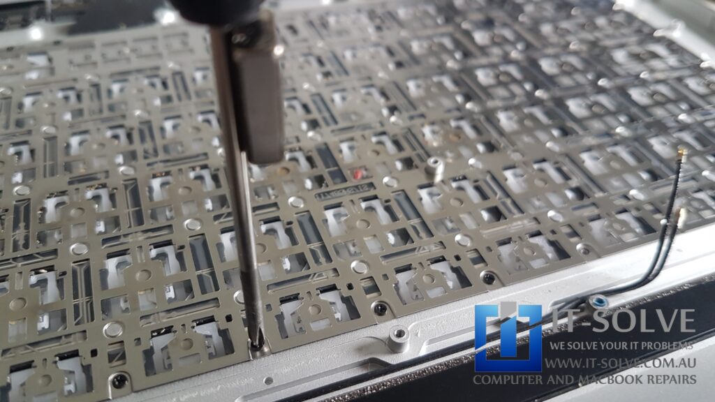 Removing screws and caps from the old keyboard