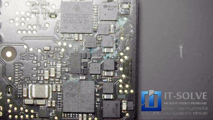 Corrosion around charging chips of Macbook Air with water damage